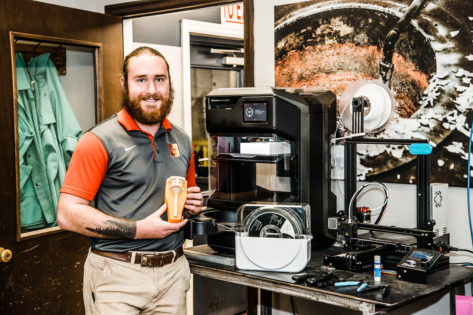 engineer poses with casting machinery